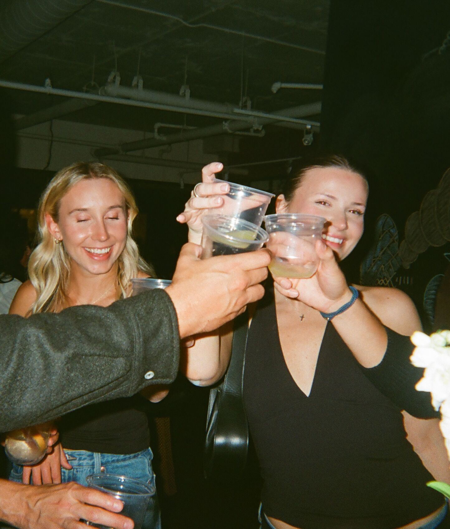 Guests reaching in to clink their spritzes at the Sprizzini pop-up in Mount Pleasant