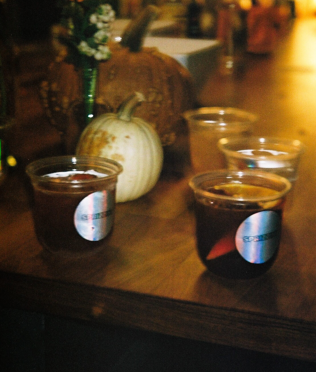 Dark red drinks in clear cups with holographic Sprizzini stickers